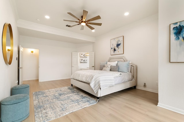 bedroom featuring crown molding, ceiling fan, and light hardwood / wood-style floors