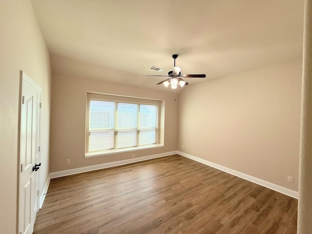 spare room featuring wood-type flooring and ceiling fan