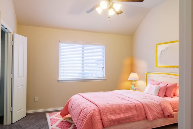 bedroom with ceiling fan, lofted ceiling, and dark carpet