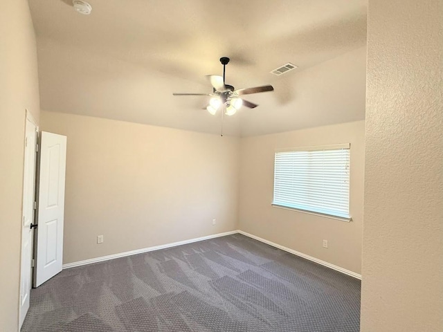 carpeted spare room with ceiling fan