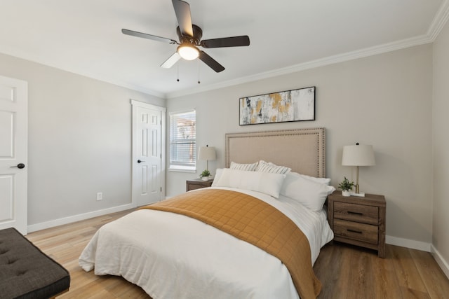 bedroom featuring wood-type flooring, ornamental molding, ceiling fan, and a closet