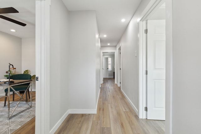 hallway with light hardwood / wood-style flooring