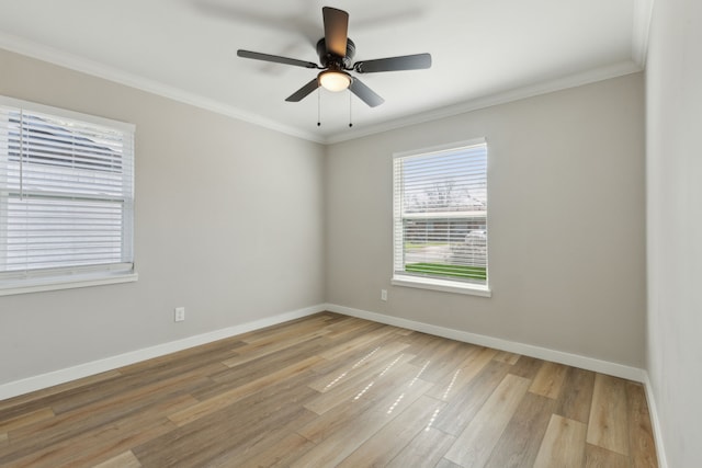 empty room with ornamental molding, ceiling fan, and light wood-type flooring