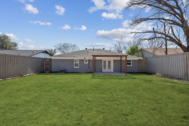 back of property with a patio area, a lawn, central AC unit, and french doors