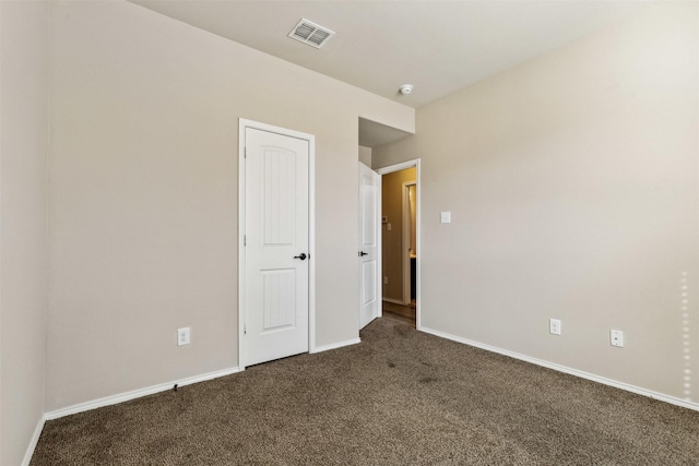 unfurnished bedroom featuring dark carpet