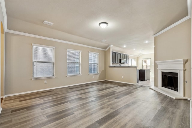 unfurnished living room with ornamental molding and wood-type flooring