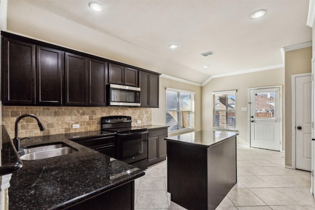 kitchen with sink, crown molding, black electric range, a kitchen island, and dark stone counters