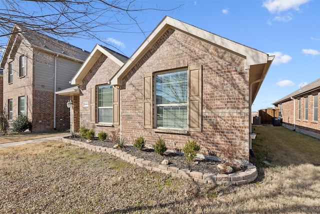 view of property exterior featuring central AC unit and a lawn