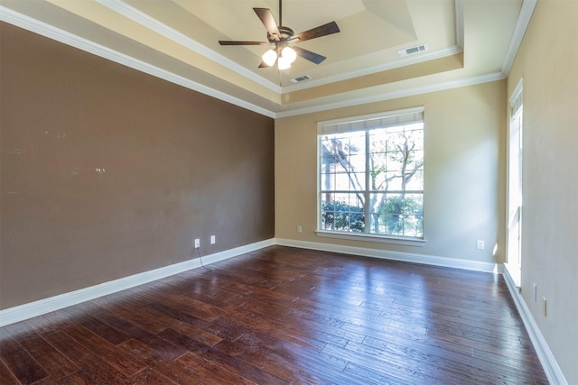 unfurnished room with dark hardwood / wood-style floors, ornamental molding, a raised ceiling, and ceiling fan