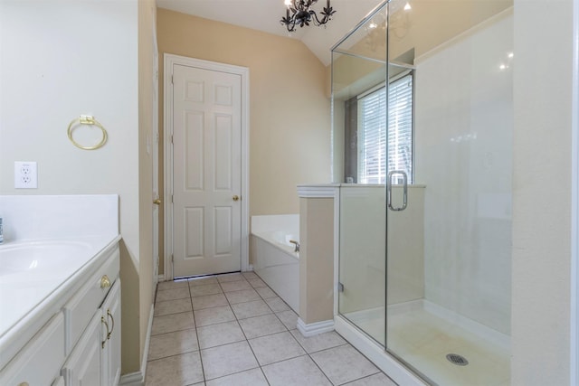 bathroom featuring vaulted ceiling, vanity, a notable chandelier, plus walk in shower, and tile patterned flooring