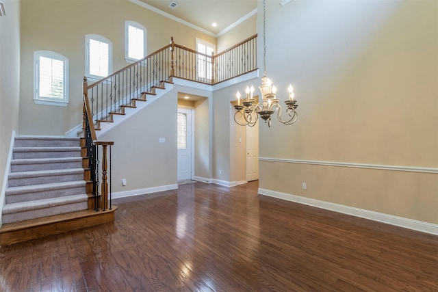 interior space with dark hardwood / wood-style floors, a wealth of natural light, and a chandelier