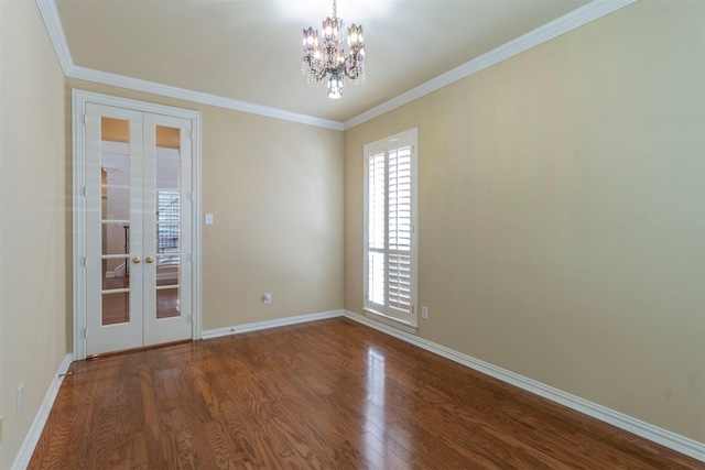 empty room with crown molding, hardwood / wood-style flooring, and french doors