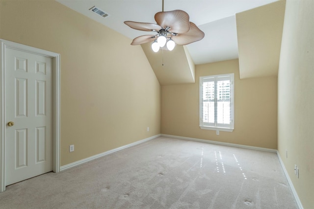 additional living space featuring light carpet, lofted ceiling, and ceiling fan