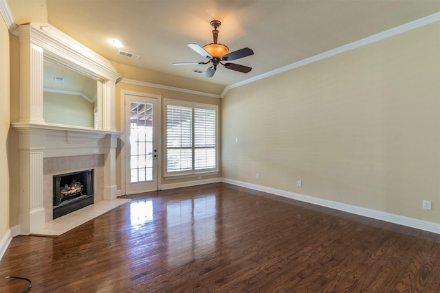 unfurnished living room with hardwood / wood-style flooring, ceiling fan, ornamental molding, and a tile fireplace