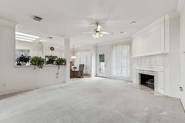 unfurnished living room featuring light carpet, crown molding, a premium fireplace, and ceiling fan