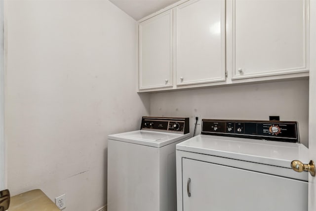 washroom featuring cabinets and washer and dryer