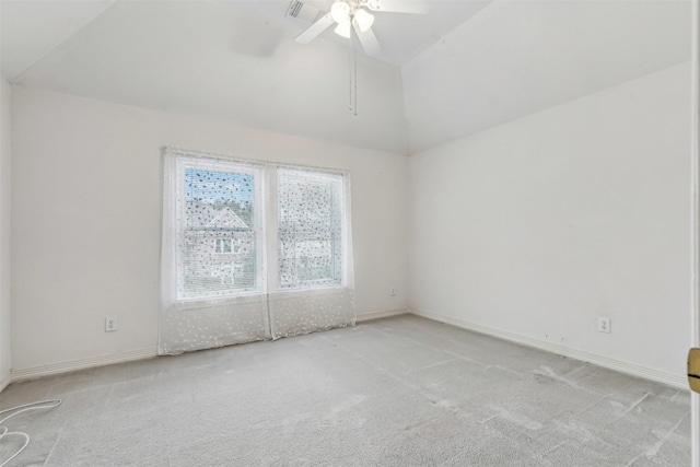 carpeted spare room featuring lofted ceiling and ceiling fan