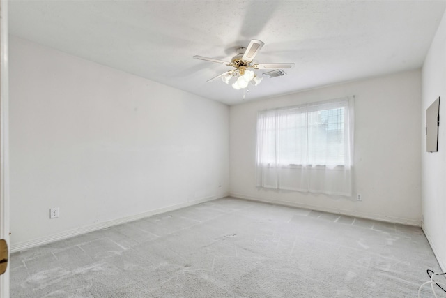 spare room with light colored carpet and ceiling fan