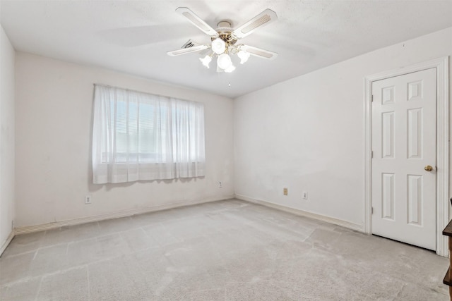 empty room with light carpet and ceiling fan