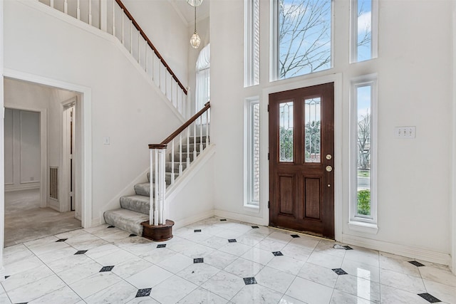 entryway with a towering ceiling