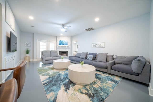 living area with concrete floors, visible vents, a fireplace, and recessed lighting