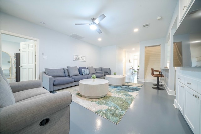 living room with concrete flooring, ceiling fan, visible vents, and recessed lighting