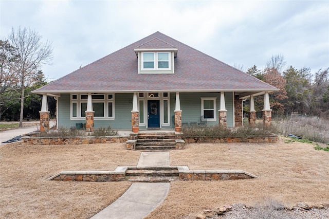 view of front of house featuring a porch and roof with shingles