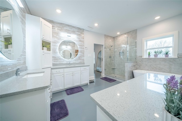 full bath featuring decorative backsplash, recessed lighting, a sink, and a shower stall