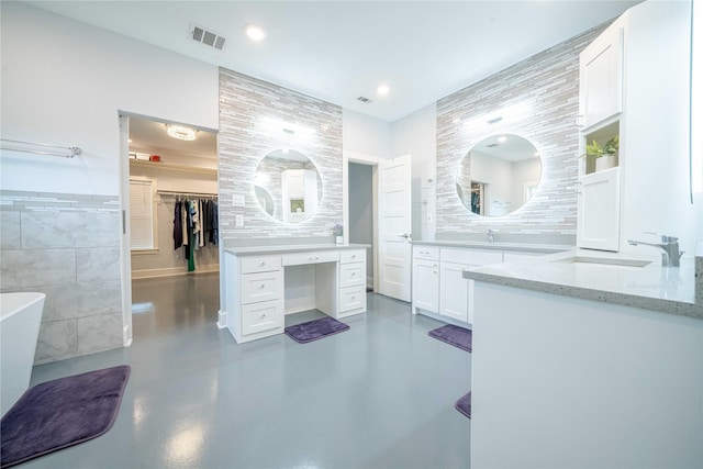 full bathroom featuring recessed lighting, a soaking tub, visible vents, finished concrete floors, and vanity