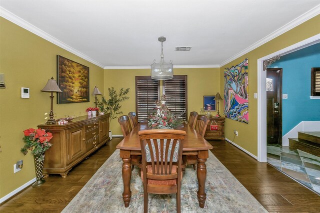 dining room with dark wood-type flooring and ornamental molding