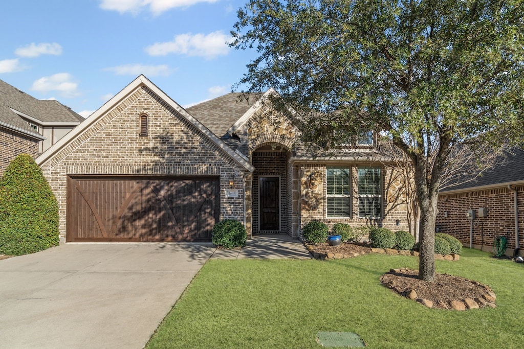 view of front of house with a garage and a front yard