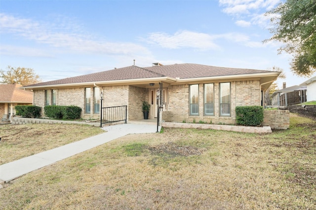 ranch-style home with a front lawn