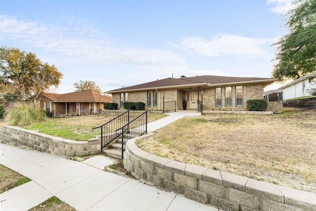 ranch-style home featuring a front yard