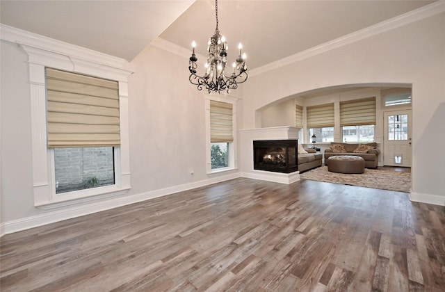 unfurnished living room featuring crown molding, hardwood / wood-style flooring, and a multi sided fireplace