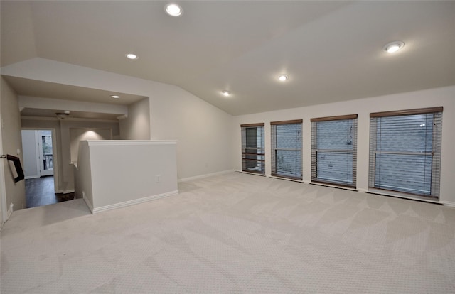 empty room featuring lofted ceiling and light colored carpet