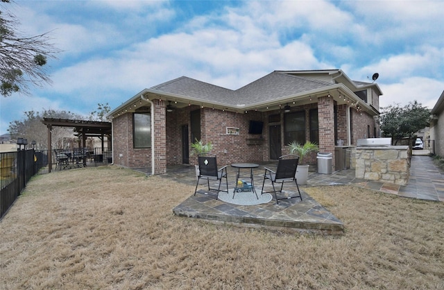 rear view of property featuring area for grilling, a yard, and a patio area