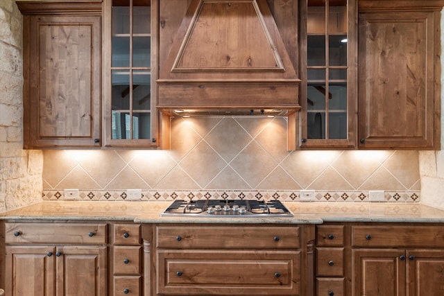 402 N Parkway Dr, Alvarado, TX 76009 - kitchen featuring stainless steel gas stovetop, premium range hood, backsplash, and light stone counters