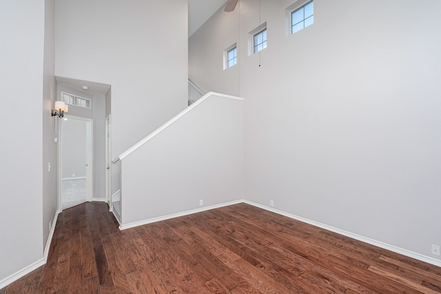 interior space featuring dark hardwood / wood-style flooring and a high ceiling