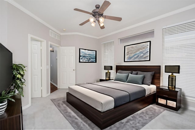 bedroom with crown molding, light carpet, and ceiling fan