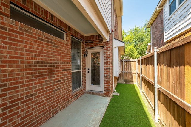 entrance to property featuring a yard