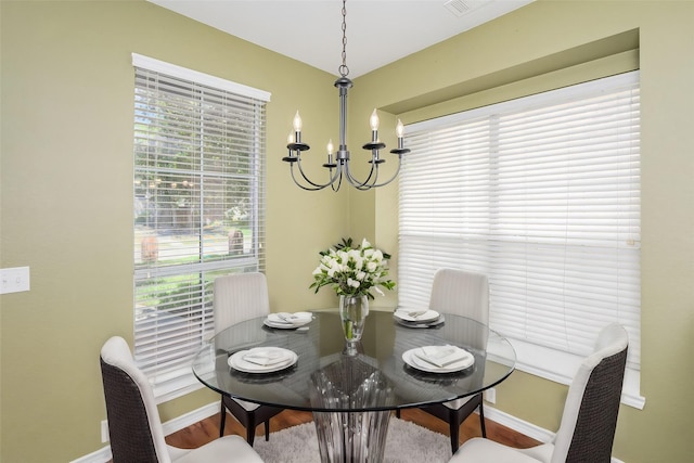 dining room featuring wood-type flooring and a chandelier