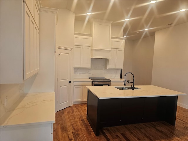 kitchen featuring white cabinetry, sink, an island with sink, and stainless steel range with electric stovetop