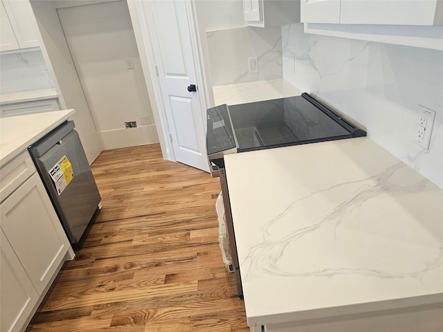 kitchen featuring white cabinetry, decorative backsplash, dishwasher, and light wood-type flooring