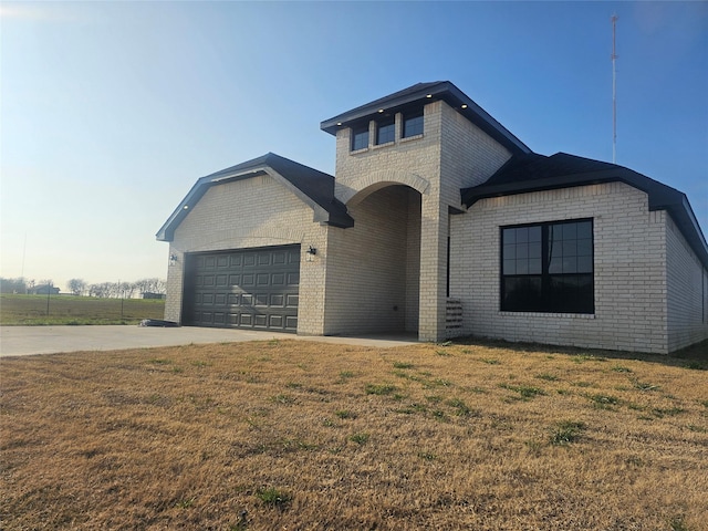 view of front of house with a garage and a front lawn