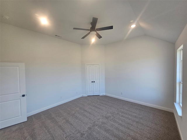 unfurnished room with vaulted ceiling, carpet floors, and ceiling fan