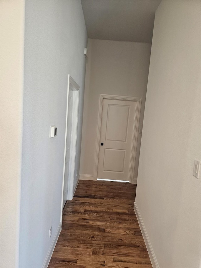 hallway with dark hardwood / wood-style floors