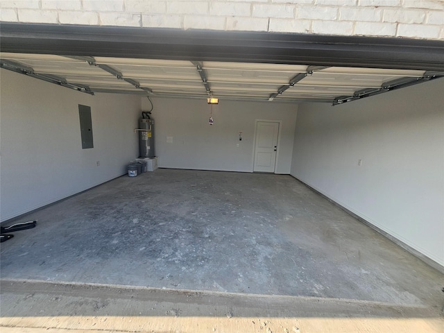 garage featuring electric panel and water heater