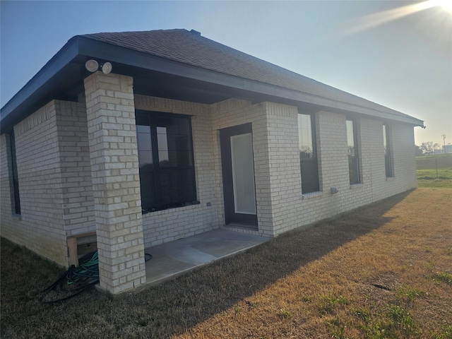 view of property exterior with a lawn