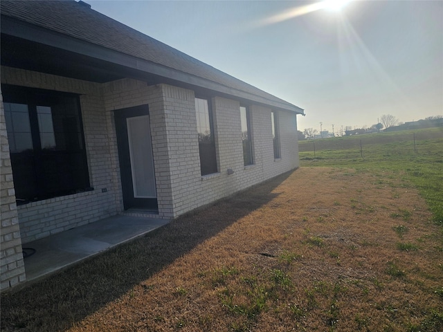 view of home's exterior with a lawn