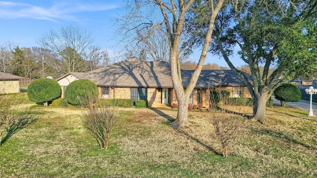 ranch-style house with a front lawn